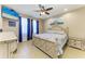 Cozy main bedroom featuring a large bed, ceiling fan, and beach-themed décor at 8243 Nandina Dr, Sarasota, FL 34240