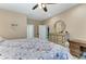 Bedroom featuring a patterned bed, ceiling fan, lots of natural light, and coastal-themed decor at 8243 Nandina Dr, Sarasota, FL 34240