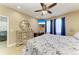Bedroom featuring a patterned bed, a ceiling fan, natural light and coastal themed decor at 8243 Nandina Dr, Sarasota, FL 34240