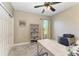 Well-lit home office with neutral decor, bookshelves and a ceiling fan at 8243 Nandina Dr, Sarasota, FL 34240