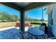 Covered patio features a hot tub and outdoor furniture with views of the green lawn at 8243 Nandina Dr, Sarasota, FL 34240