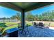 Inviting patio with an outdoor dining and seating area overlooking the yard at 8243 Nandina Dr, Sarasota, FL 34240