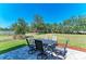 Open patio area includes an outdoor dining set perfect for entertaining guests with a grass lawn at 8243 Nandina Dr, Sarasota, FL 34240