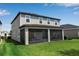 Two-story home featuring a screened-in lanai, set on a large, lush green backyard lawn at 8346 Abalone Loop, Parrish, FL 34219