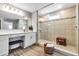 Bright bathroom featuring a large tiled shower, double vanity, and wood-look flooring at 8346 Abalone Loop, Parrish, FL 34219