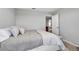 Bedroom with an open doorway, a comfortable queen-size bed, and neutral decor at 8346 Abalone Loop, Parrish, FL 34219