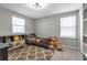 Well-lit bedroom featuring two large windows and decor with fun colors and themes at 8346 Abalone Loop, Parrish, FL 34219