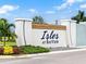 Isles at Bayview community entrance sign featuring lush landscaping and modern design elements at 8346 Abalone Loop, Parrish, FL 34219
