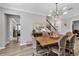 Dining room with seating for six, contemporary chandelier, and seamless access to other living areas at 8346 Abalone Loop, Parrish, FL 34219