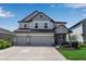 Beautiful two-story home with a three-car garage, gray paint, and welcoming front entrance at 8346 Abalone Loop, Parrish, FL 34219