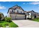 Two-story home featuring a three-car garage, neutral paint, and well-manicured lawn at 8346 Abalone Loop, Parrish, FL 34219