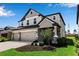 Beautiful two-story home with a three-car garage, manicured lawn, and stone accents at 8346 Abalone Loop, Parrish, FL 34219