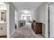 Hallway with carpet, wooden cabinet, and access to other rooms and features of the house at 8346 Abalone Loop, Parrish, FL 34219