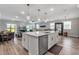 Open kitchen featuring a central island, stainless steel appliances, and views into the living area at 8346 Abalone Loop, Parrish, FL 34219
