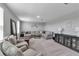 Well-lit living room boasts neutral paint, plush carpeting, and a comfortable, oversized sectional sofa at 8346 Abalone Loop, Parrish, FL 34219