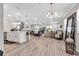 Spacious living room with open layout, wood-look flooring, and recessed lighting at 8346 Abalone Loop, Parrish, FL 34219