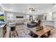 Spacious living room featuring a plush sectional, large windows, and an open layout at 8346 Abalone Loop, Parrish, FL 34219