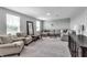 Spacious living room featuring plush carpeting, a sectional couch, and plenty of natural light at 8346 Abalone Loop, Parrish, FL 34219