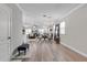 Open-concept living room with wood-look flooring and elegant furnishings at 8346 Abalone Loop, Parrish, FL 34219
