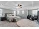 Spacious main bedroom with a tray ceiling, carpeted floors, and a decorative ceiling fan at 8346 Abalone Loop, Parrish, FL 34219