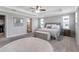 Spacious main bedroom featuring a ceiling fan, tray ceiling, and ensuite bathroom at 8346 Abalone Loop, Parrish, FL 34219