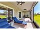 Relaxing screened-in patio featuring ceiling fans and comfortable chaise lounge seating at 8346 Abalone Loop, Parrish, FL 34219