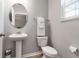 Stylish powder room with pedestal sink, toilet, and modern fixtures at 8346 Abalone Loop, Parrish, FL 34219