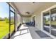 Relaxing screened porch with ceiling fans and a view of the green lawn at 8346 Abalone Loop, Parrish, FL 34219