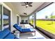 Relaxing screened porch with ceiling fans and lounge chairs overlooking the backyard at 8346 Abalone Loop, Parrish, FL 34219