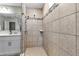 Bright and modern tiled shower with glass door and shower head at 8346 Abalone Loop, Parrish, FL 34219