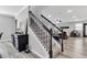 Elegant staircase with dark wood railing and white risers, leading to a spacious living area at 8346 Abalone Loop, Parrish, FL 34219