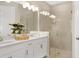 Modern bathroom featuring double sinks, a glass-enclosed shower, and contemporary fixtures at 8505 Snowfall St, Sarasota, FL 34241