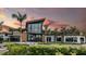 Stunning clubhouse exterior with contemporary architecture, lush greenery, and a beautifully designed entrance at 8505 Snowfall St, Sarasota, FL 34241