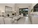 Cozy living room with stylish furniture, neutral tones, and large sliding doors offering a pool view at 8505 Snowfall St, Sarasota, FL 34241