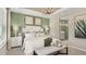 Elegant main bedroom with a decorative lighting fixture and a luxurious ensuite bathroom at 8505 Snowfall St, Sarasota, FL 34241