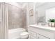Well-lit bathroom featuring a shower-tub combination and a bright vanity with ample storage at 9095 Rally Spring Loop, Wesley Chapel, FL 33545