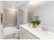 Well-appointed bathroom with double sinks, a shower-tub combination, and neutral-toned tile work at 9095 Rally Spring Loop, Wesley Chapel, FL 33545