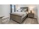 Cozy bedroom featuring a comfortable bed with decorative pillows and a stylish nightstand with a lamp at 9095 Rally Spring Loop, Wesley Chapel, FL 33545