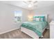 Bright bedroom showcasing a comfortable bed, a window offering natural light, and a clean, simple design at 9095 Rally Spring Loop, Wesley Chapel, FL 33545