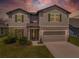 Charming two-story home with a welcoming entrance, well-kept lawn, and attached two-car garage at 9095 Rally Spring Loop, Wesley Chapel, FL 33545