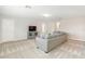 Spacious living room featuring a comfortable sofa, a modern entertainment center, and neutral decor at 9095 Rally Spring Loop, Wesley Chapel, FL 33545