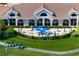 An aerial view of outdoor patio dining, lawn, golf carts and golf course at 9630 Club South Cir # 6201, Sarasota, FL 34238