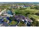An expansive aerial view of clubhouse, tennis courts, golf course, swimming pool, and parking at 9630 Club South Cir # 6201, Sarasota, FL 34238