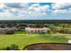 Beautiful aerial view showcases golf course, ponds, and residential buildings with lake views at 9630 Club South Cir # 6201, Sarasota, FL 34238