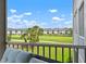 A screen enclosed balcony overlooking a lush green space and a pond at 9630 Club South Cir # 6201, Sarasota, FL 34238