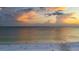Beautiful beach view featuring a colorful sunset and soft, white sand at 9630 Club South Cir # 6201, Sarasota, FL 34238