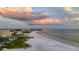 A beach scene with colorful sunset clouds and a tranquil coastline; calm waters, and soft sands at 9630 Club South Cir # 6201, Sarasota, FL 34238