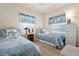 Coastal-themed bedroom with two twin beds, light wood floors, and white wicker furniture at 9630 Club South Cir # 6201, Sarasota, FL 34238