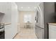 Eat-in kitchen with neutral tile flooring, stainless steel appliances, white walls, cabinets and table set at 9630 Club South Cir # 6201, Sarasota, FL 34238