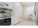 Bright eat-in kitchen features neutral tile flooring, stainless steel appliances, and white cabinets and walls at 9630 Club South Cir # 6201, Sarasota, FL 34238
